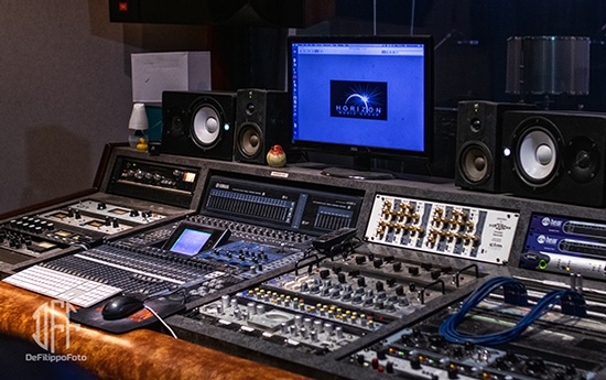 A large sound board with a monitor and speakers.